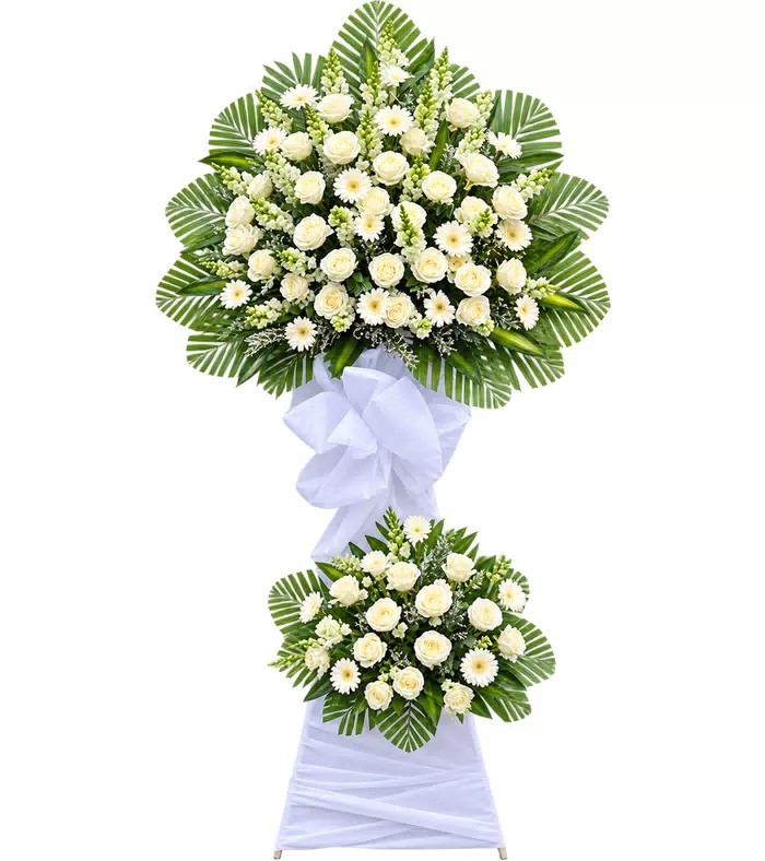 Kệ hoa viếng trắng xanh, lá xanh và vải trắng