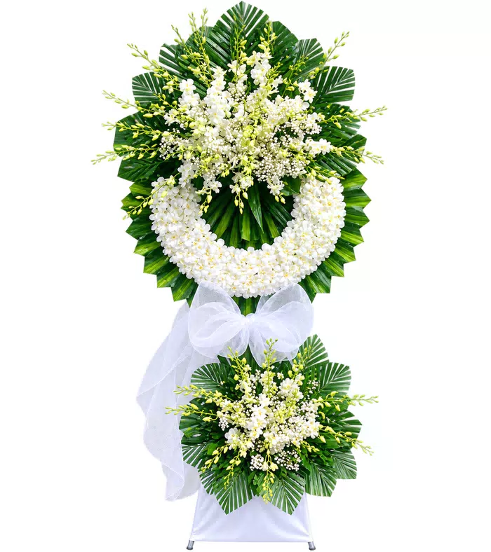 Kệ hoa viếng trắng xanh, lá xanh và vải trắng